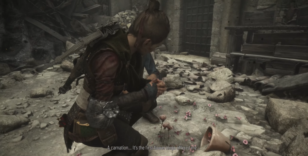 Woman kneeling among pink flowers.