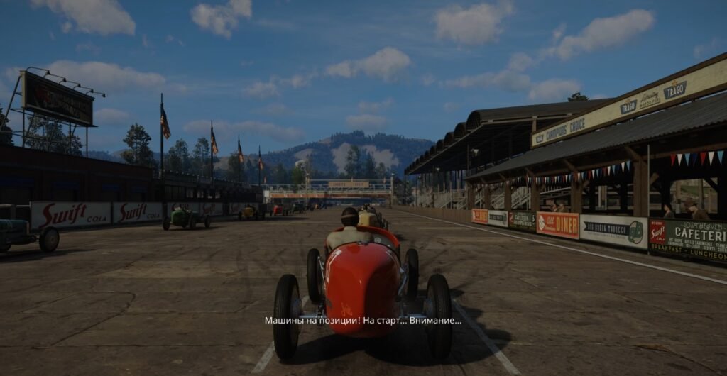 Red vintage race car lined up on track