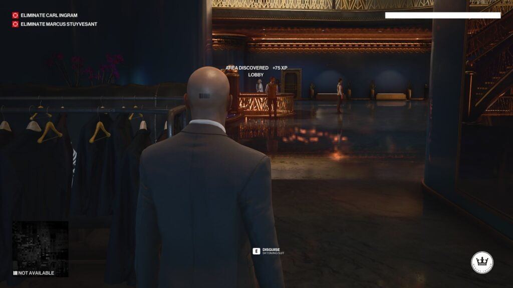 Agent 47 in Hitman stands in hotel lobby