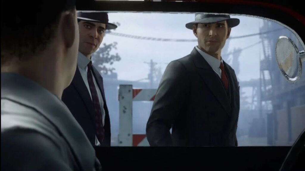 Two men in suits look into car window