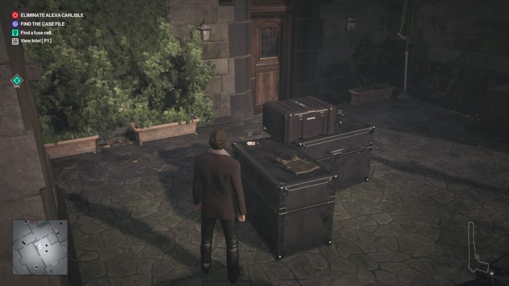 Hitman Agent 47 stands near crates in courtyard