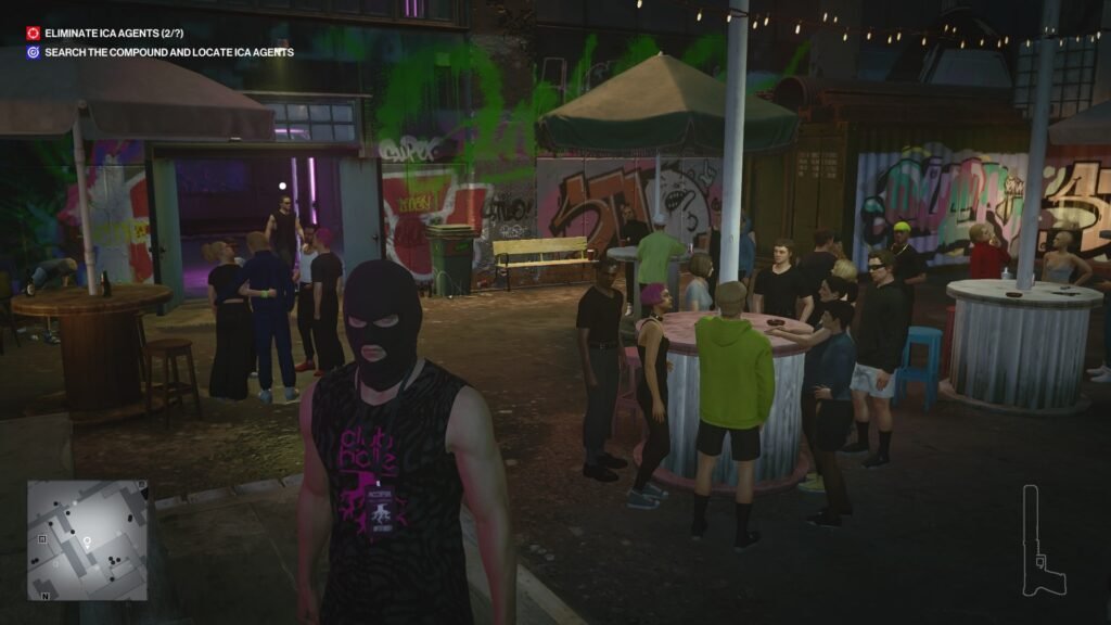Masked man standing at nightclub courtyard bar crowd in Hitman