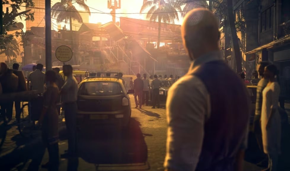 Bald man watching crowded street at sunset