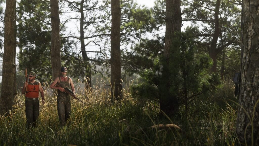 Two hunters walking through forest carrying rifles