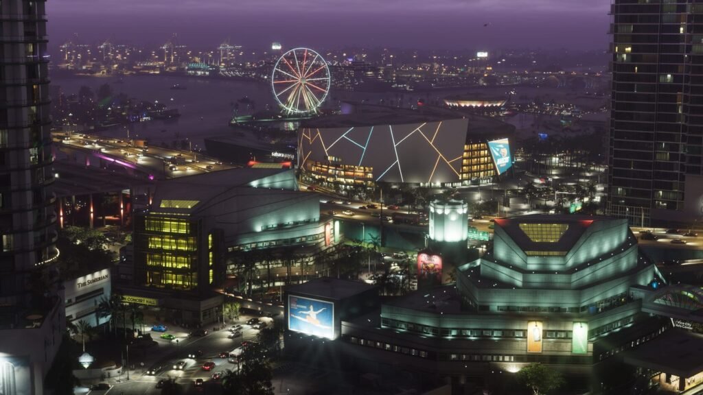 Ferris wheel glows above city buildings at night