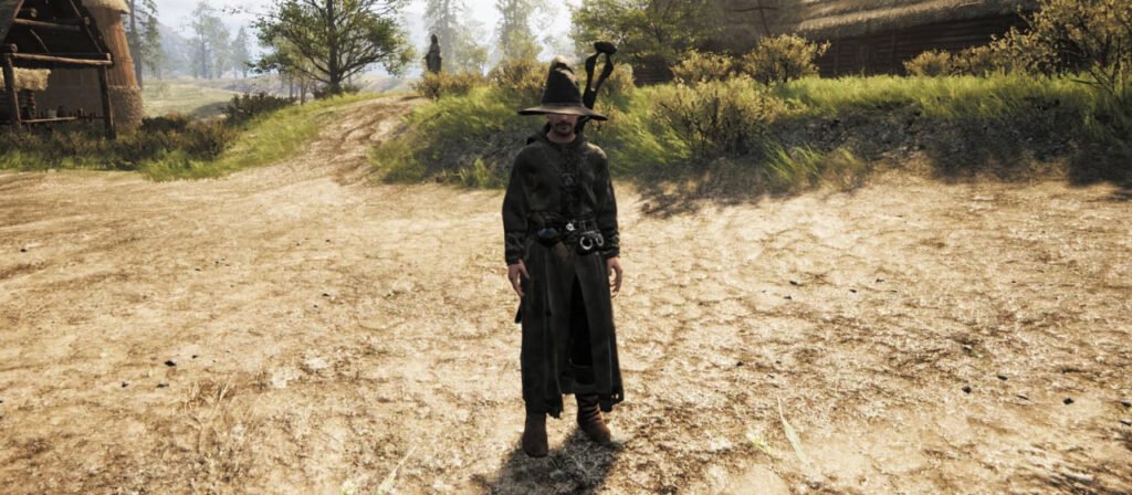 Wizard standing on dirt road near village huts
