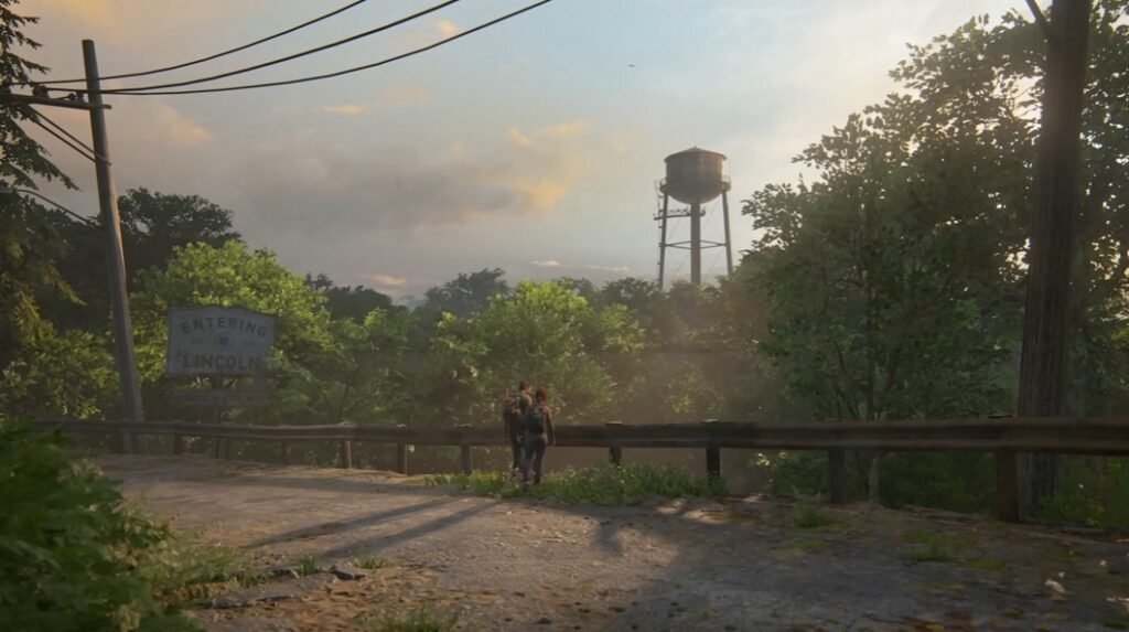 Two people walking on road near water tower